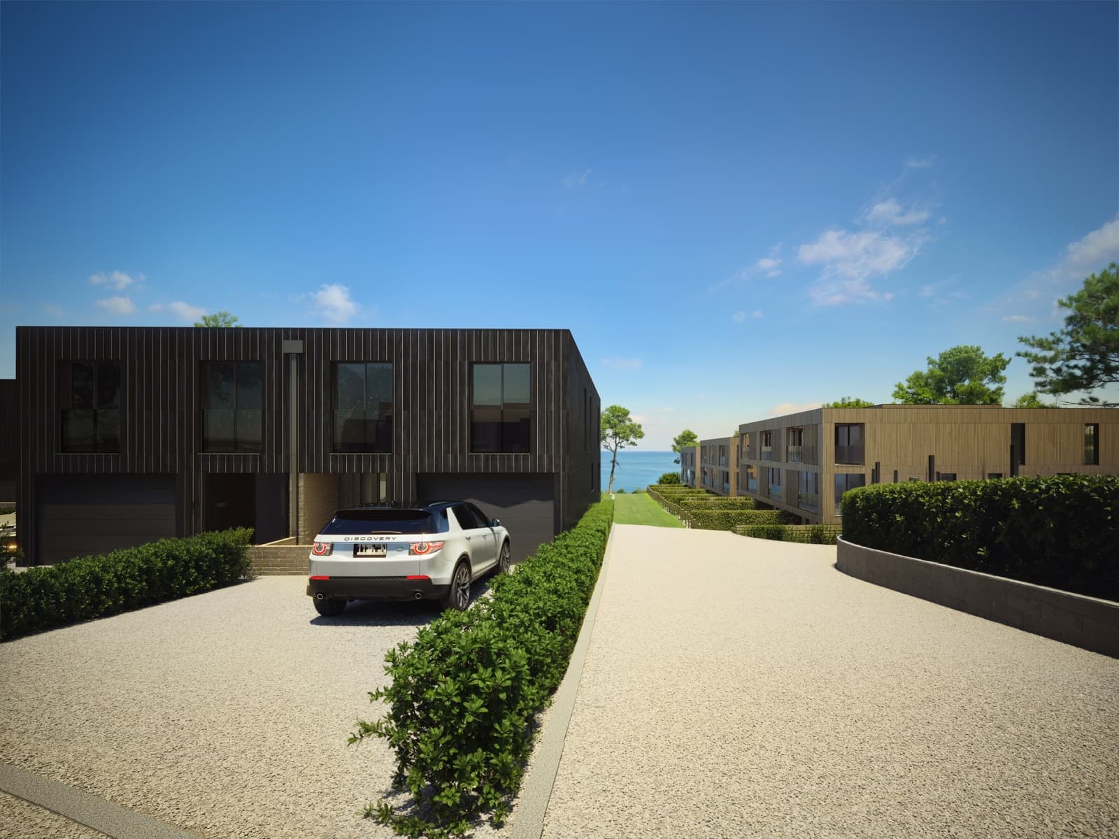Driveway and garages with sea views beyond